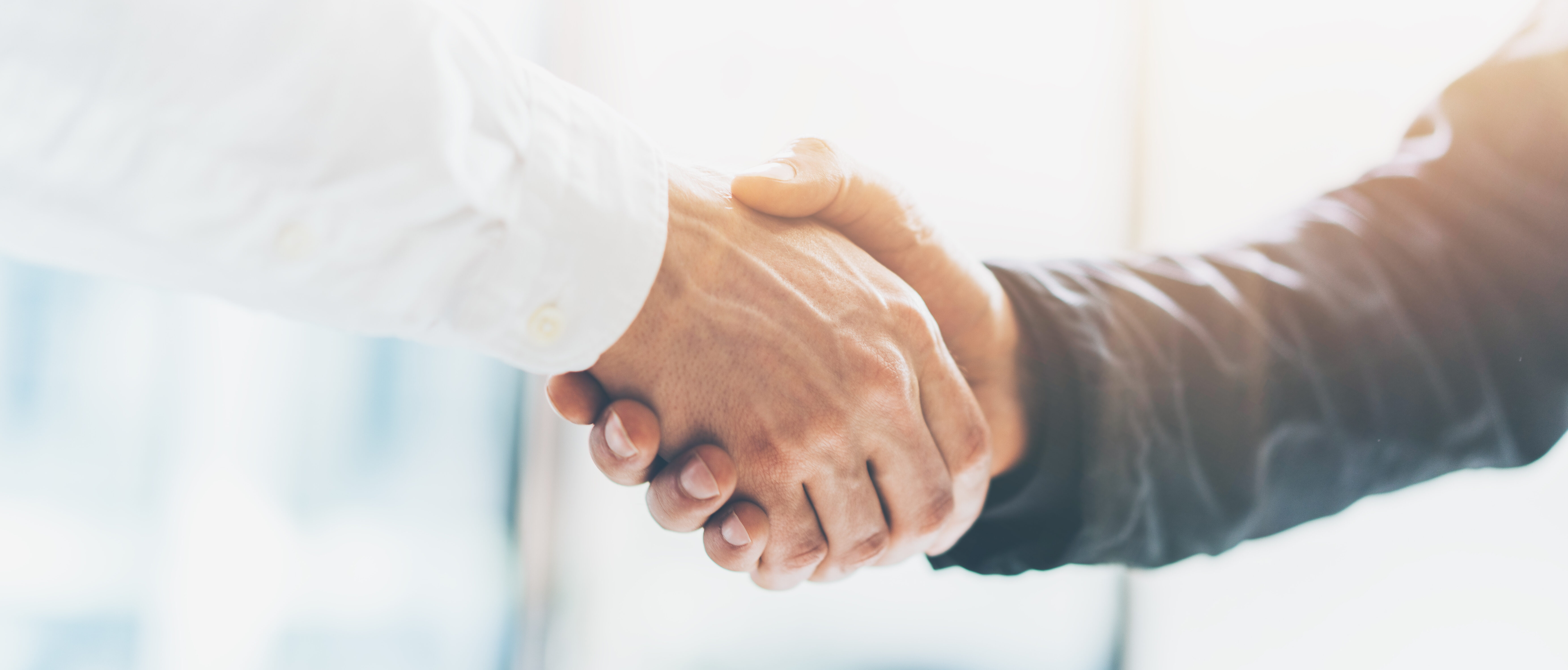 Business partnership meeting. Picture businessmans handshake. Successful businessmen handshaking after good deal. Horizontal, blurred background